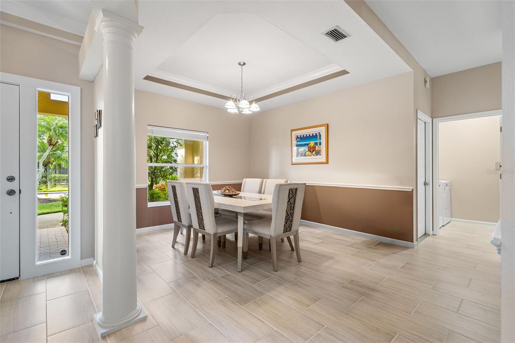 603 Pine Ranch East Road Osprey, FL 34229 - Photo 16 of 37 a view of a dining room with furniture window and wooden floor