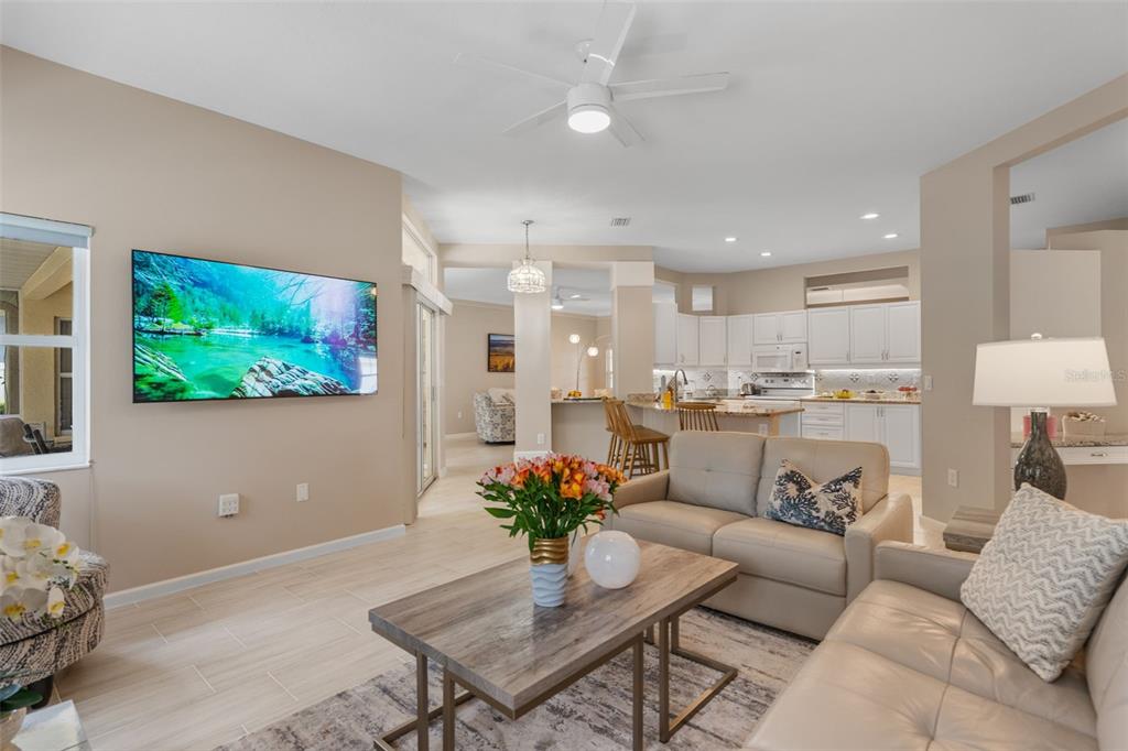 603 Pine Ranch East Road Osprey, FL 34229 - Photo 19 of 37 a living room with furniture kitchen view and a potted plant