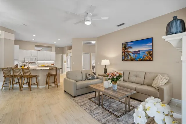 a living room with furniture and kitchen view