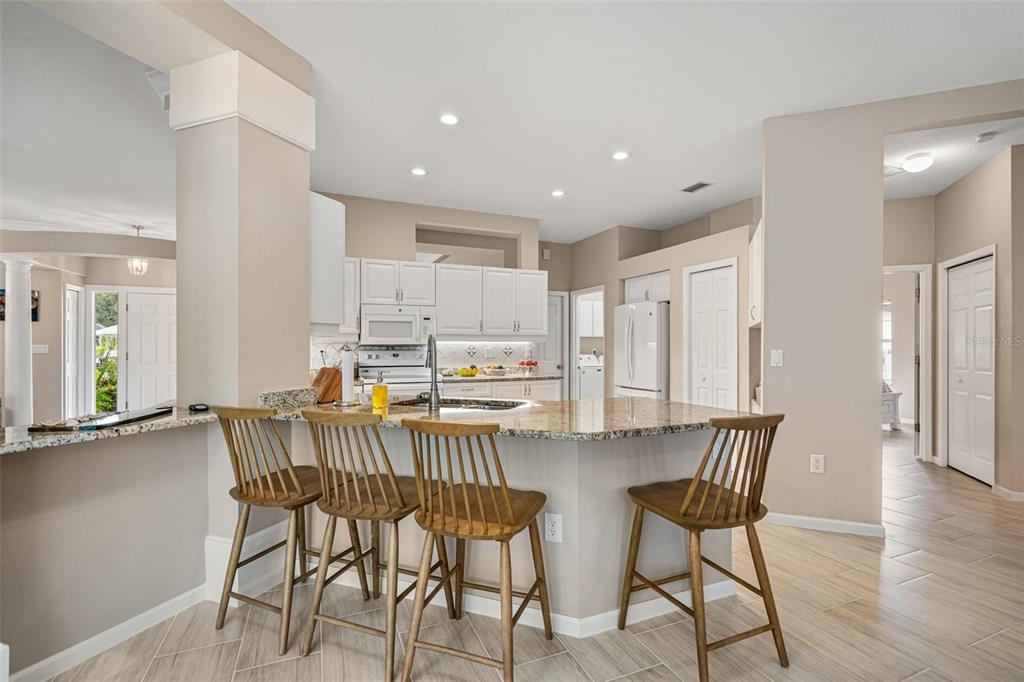 603 Pine Ranch East Road Osprey, FL 34229 - Photo 22 of 37 a view of a dining room with furniture and wooden floor