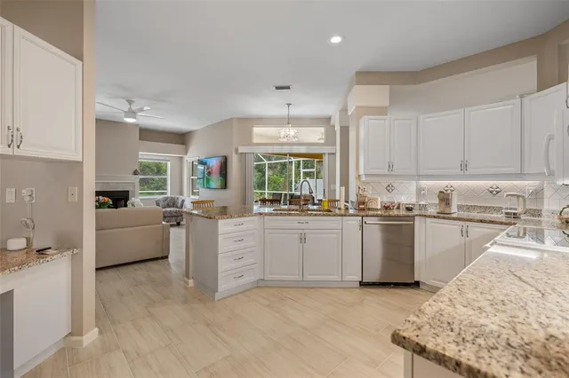 a kitchen with granite countertop a sink cabinets and window