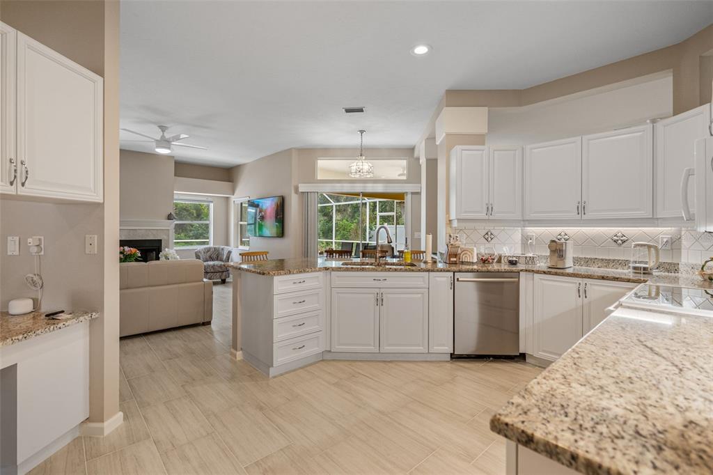 603 Pine Ranch East Road Osprey, FL 34229 - Photo 24 of 37 a kitchen with granite countertop a sink cabinets and window