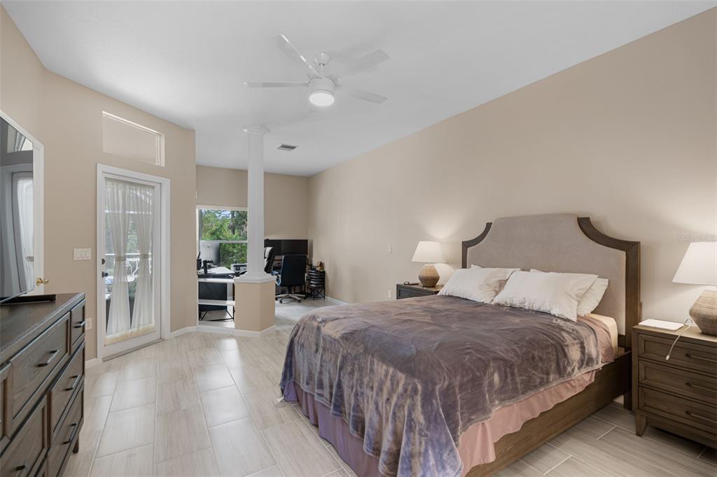 603 Pine Ranch East Road Osprey, FL 34229 - Photo 28 of 37 a spacious bedroom with a bed and a dresser with rug