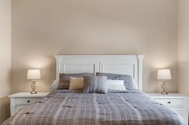 a spacious bedroom with a bed and a dresser