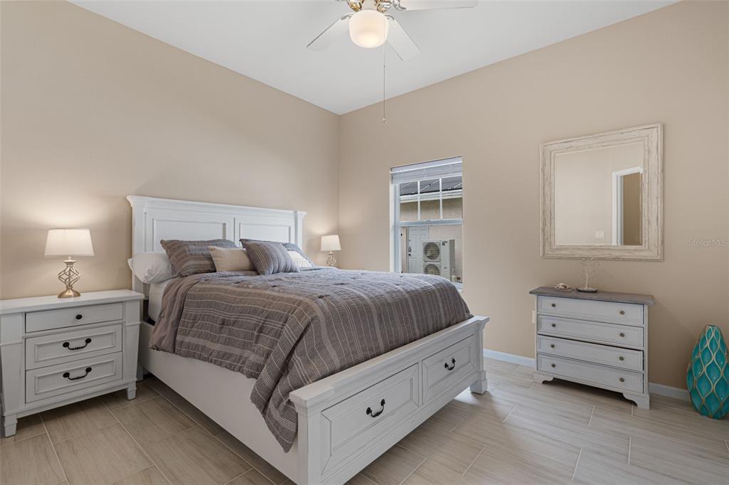 603 Pine Ranch East Road Osprey, FL 34229 - Photo 32 of 37 a spacious bedroom with a bed and a dresser