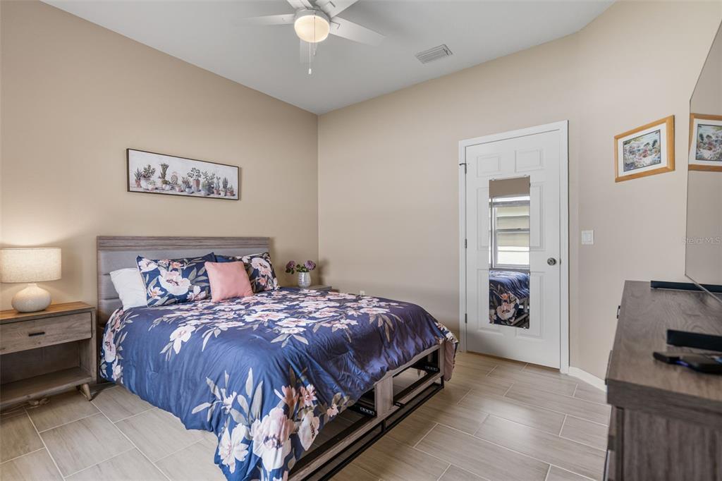 603 Pine Ranch East Road Osprey, FL 34229 - Photo 33 of 37 a bedroom with a bed and a view of kitchen