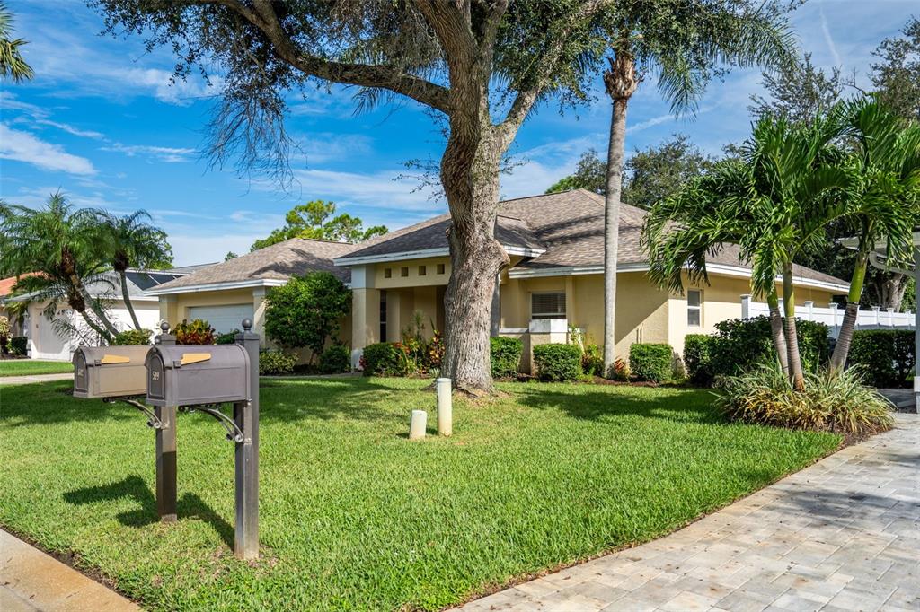 603 Pine Ranch East Road Osprey, FL 34229 - Photo 4 of 37 a view of a house with a yard and potted plants