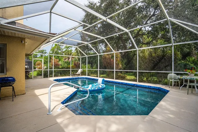 a view of a backyard with a swimming pool