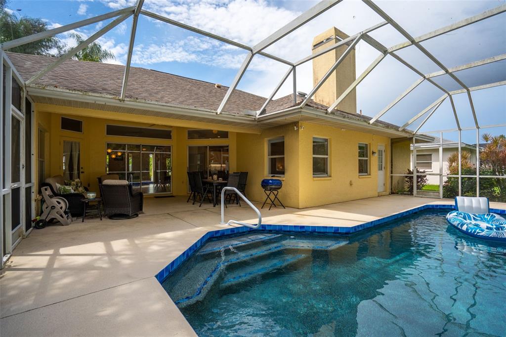 603 Pine Ranch East Road Osprey, FL 34229 - Photo 7 of 37 a backyard of a house with yard and outdoor seating