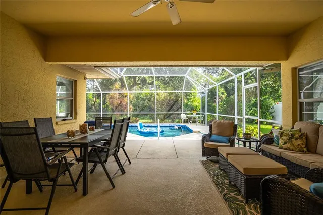 a view of a patio with couches potted plants and a dining space