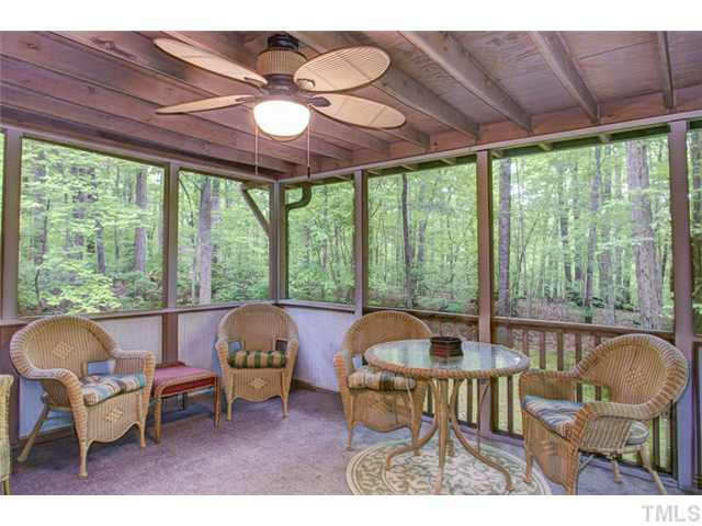 5822 Scalybark Road Durham, NC 27712 - Photo 24 of 25 The screened porch is accessible from the kitchen on the upper level. It is very large and has a ceiling fan with light. Screened Porch
