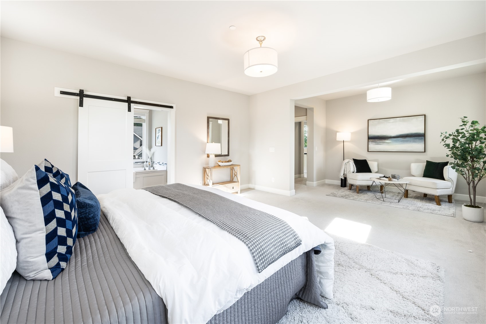 234 239th Street Southeast Bothell, WA 98021 - Photo 19 of 38 a spacious bedroom with a bed and a chandelier