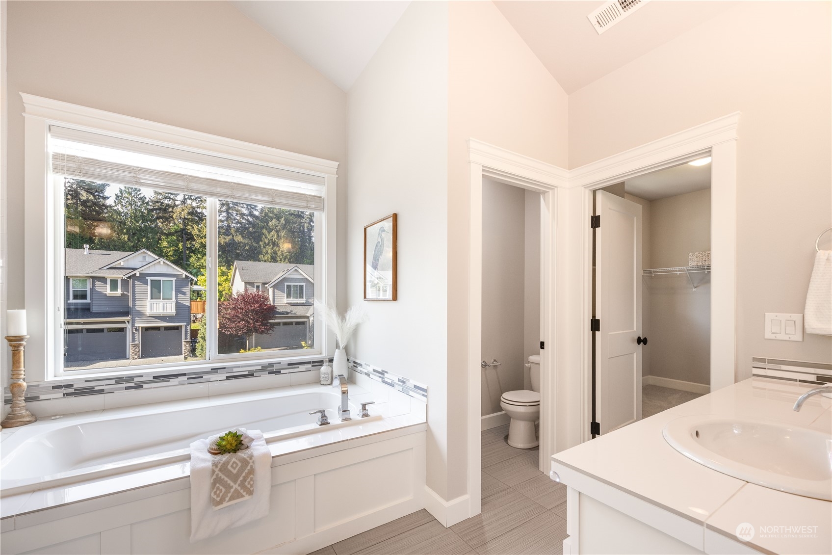 234 239th Street Southeast Bothell, WA 98021 - Photo 21 of 38 a bathroom with a tub a sink and a large window