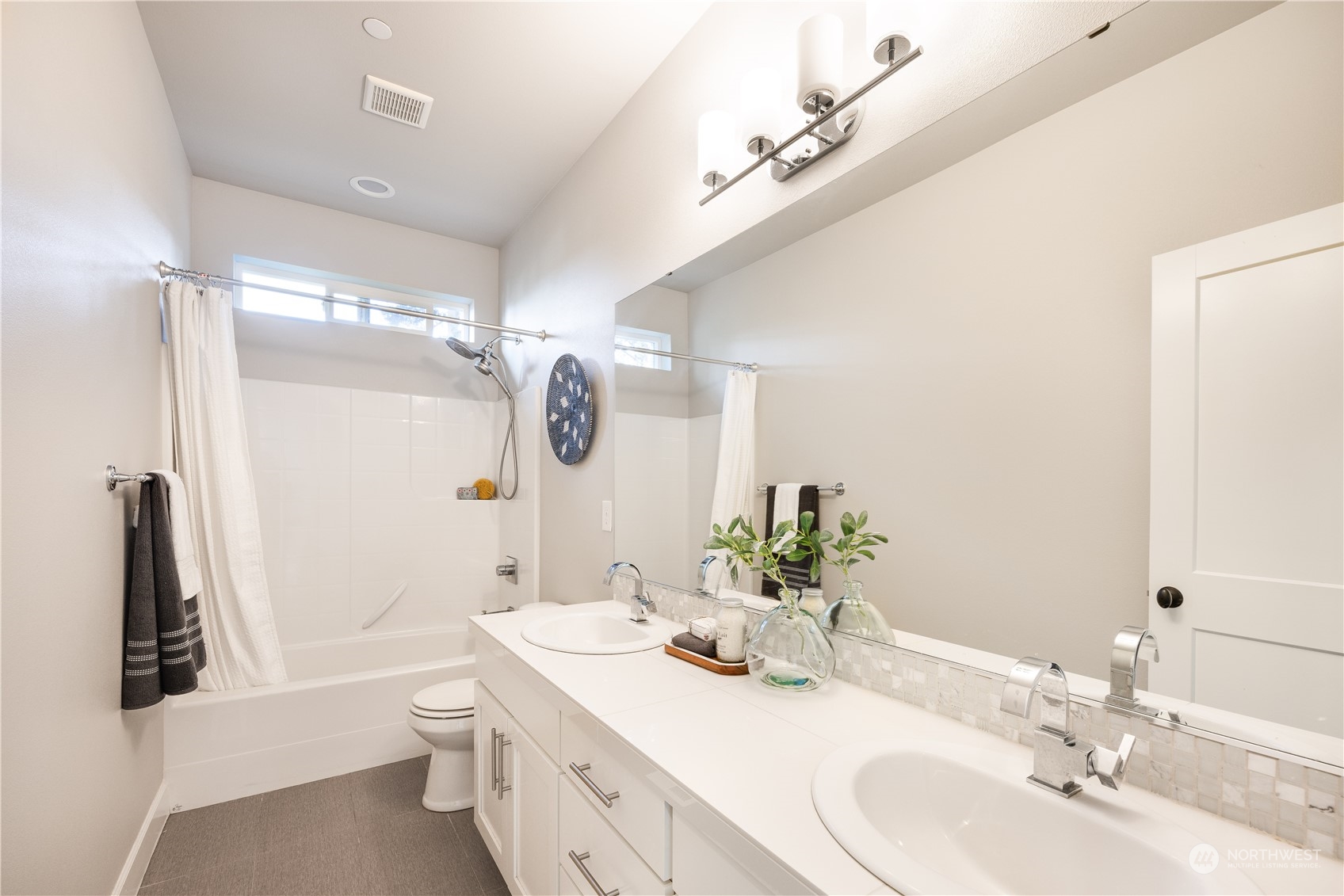 234 239th Street Southeast Bothell, WA 98021 - Photo 27 of 38 a bathroom with a double vanity sink mirror double and shower