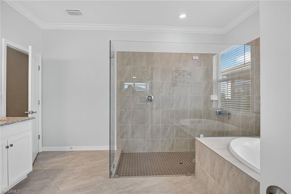 2130 Hamlin Street Naples, FL 34120 - Photo 11 of 40 a bathroom with a bathtub and a sink