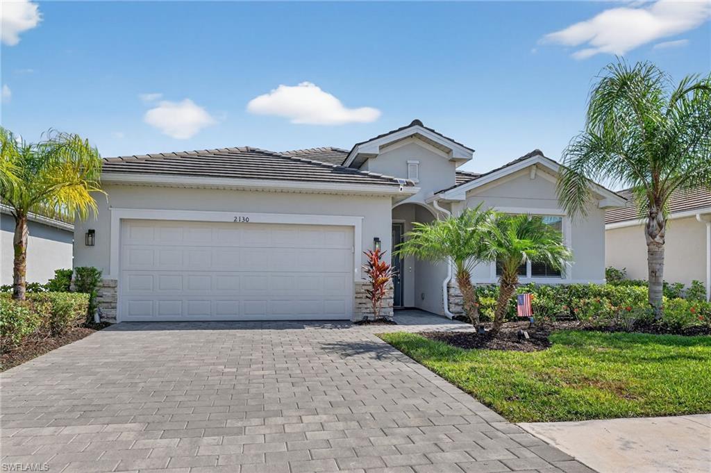 2130 Hamlin Street Naples, FL 34120 - Photo 14 of 40 a front view of a house with a yard