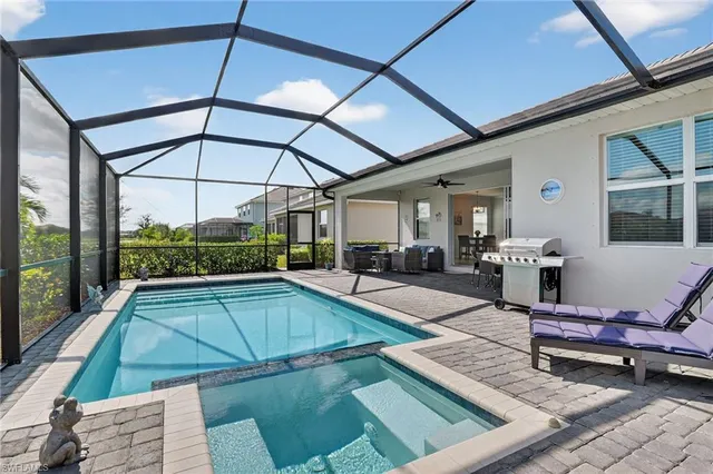 a swimming pool with outdoor seating and yard
