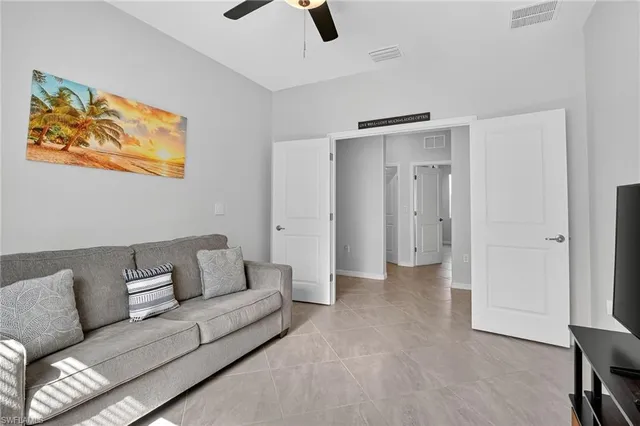a living room with furniture and a ceiling fan