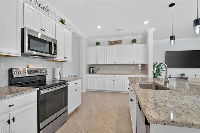 a kitchen with stainless steel appliances granite countertop a sink and stove top oven
