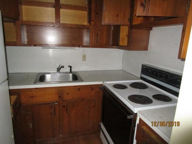 175 Woodside Road, Unit W00 West Barnstable, MA 02668 - Photo 20 of 22 a kitchen with a sink a stove and cabinets