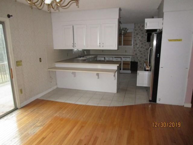 175 Woodside Road, Unit W00 West Barnstable, MA 02668 - Photo 3 of 22 a kitchen with granite countertop a stove a sink and a refrigerator