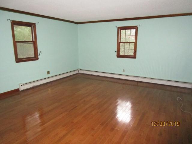 175 Woodside Road, Unit W00 West Barnstable, MA 02668 - Photo 7 of 22 an empty room with wooden floor and windows