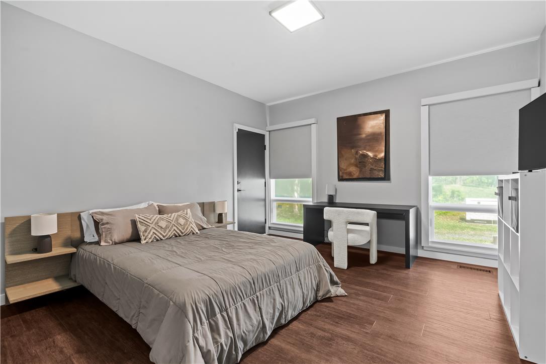 1506 Pleasant View Road Coopersburg, PA 18036 - Photo 52 of 97 Hardwood floors and generous windows create a light-filled bedroom with a modern aesthetic.