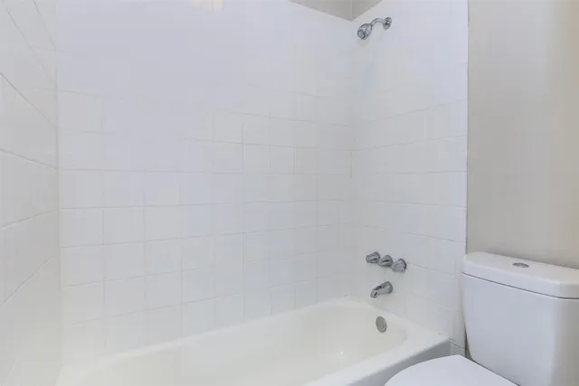 a bathroom with a bathtub and toilet