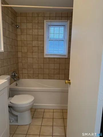 a bathroom with a toilet and a bath tub