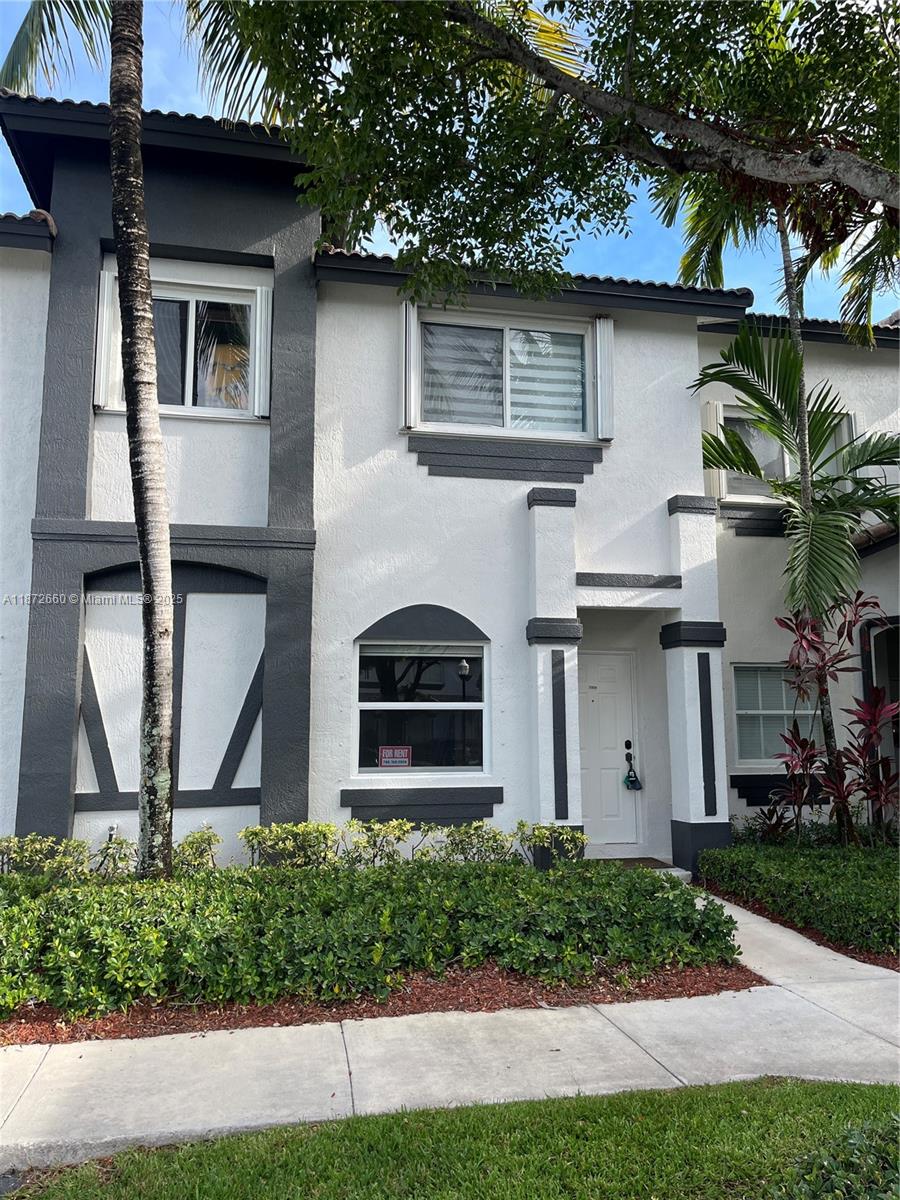 2320 Southeast 23rd Road, Unit 2320 Homestead, FL 33035 - Photo 1 of 20 a front view of house with yard