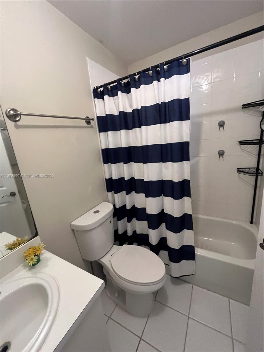 2320 Southeast 23rd Road, Unit 2320 Homestead, FL 33035 - Photo 12 of 20 a white toilet sitting next to a bathroom sink