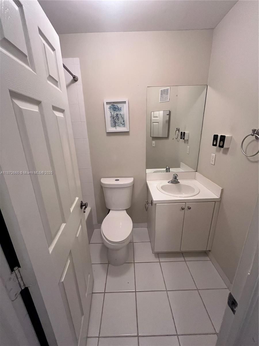 2320 Southeast 23rd Road, Unit 2320 Homestead, FL 33035 - Photo 16 of 20 a view of a bathroom with a sink and mirror