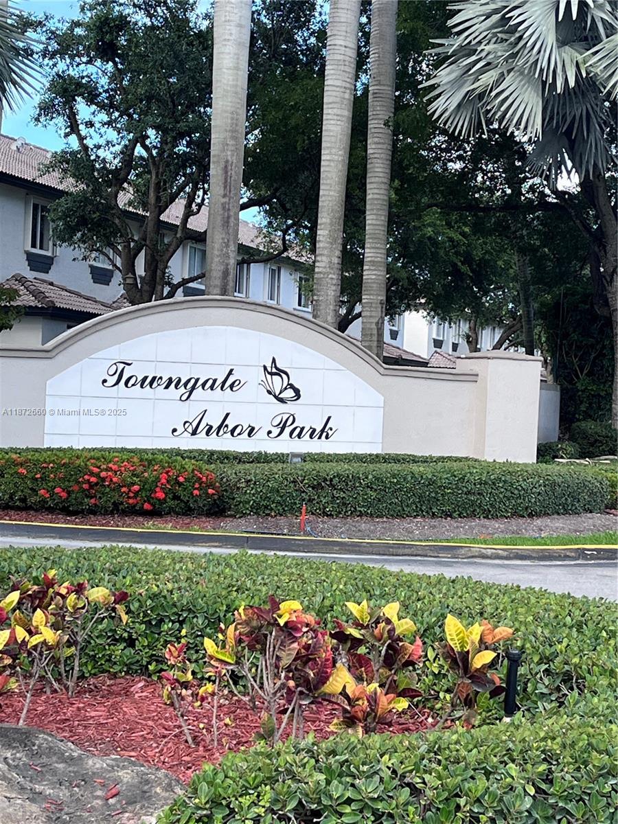 2320 Southeast 23rd Road, Unit 2320 Homestead, FL 33035 - Photo 2 of 20 front view of a multi story building with a yard and potted plants
