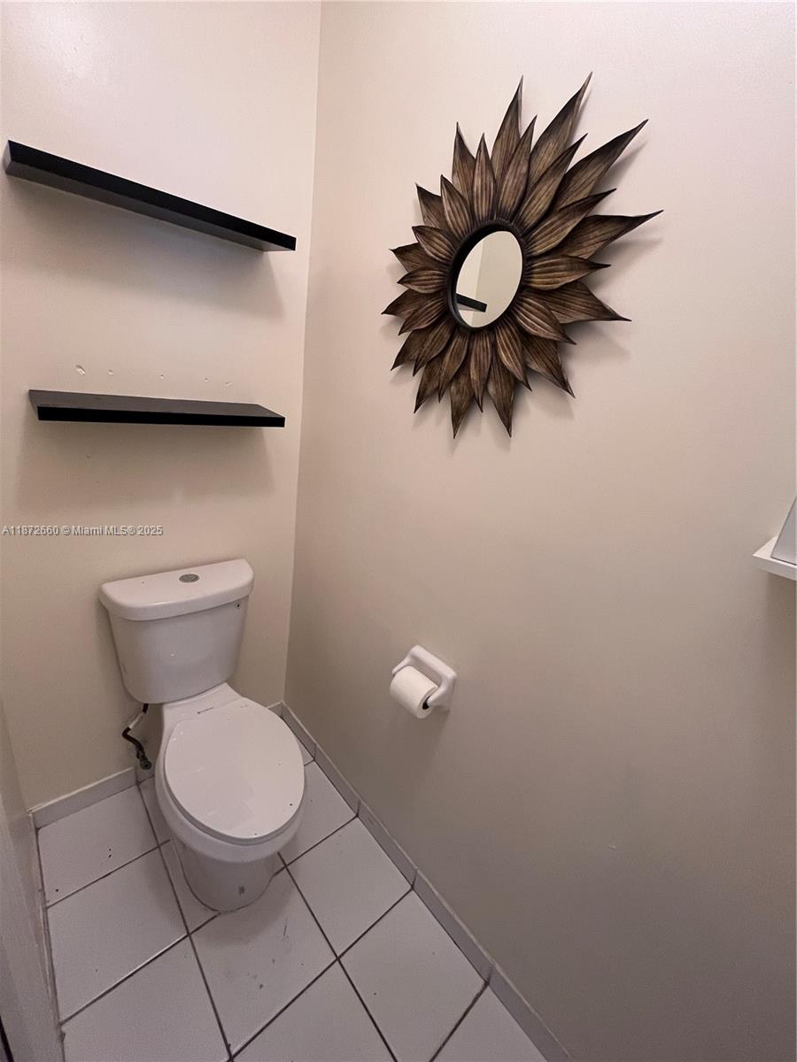 2320 Southeast 23rd Road, Unit 2320 Homestead, FL 33035 - Photo 5 of 20 a bathroom with a toilet and a mirror