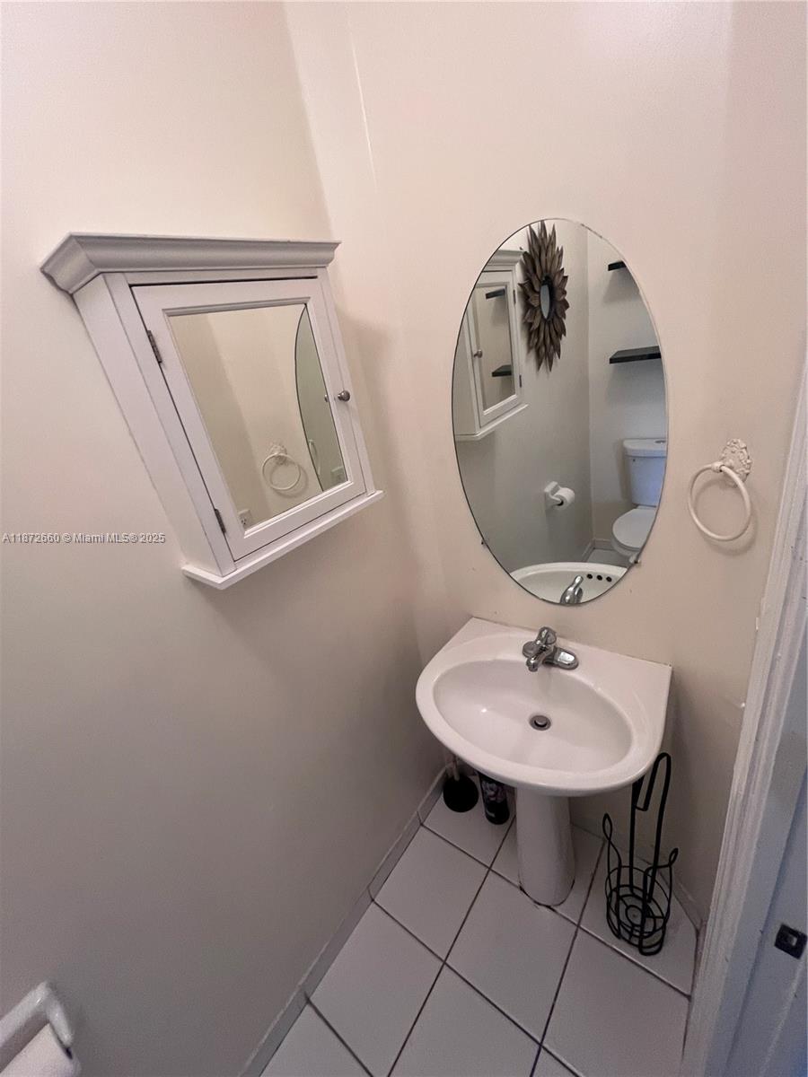2320 Southeast 23rd Road, Unit 2320 Homestead, FL 33035 - Photo 6 of 20 a bathroom with a sink and a mirror