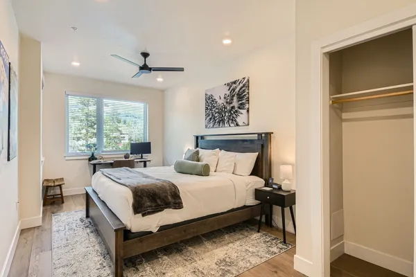 a bedroom with a bed lamp and a window