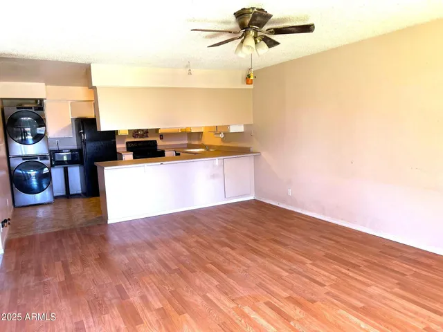 a kitchen with a sink cabinets and wooden floor