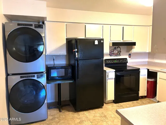 a kitchen with a refrigerator and washer