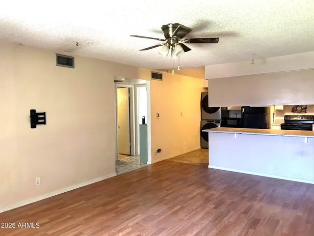 a view of a kitchen with a sink and wooden floor
