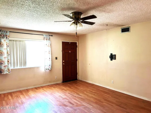 wooden floor in an empty room with a window