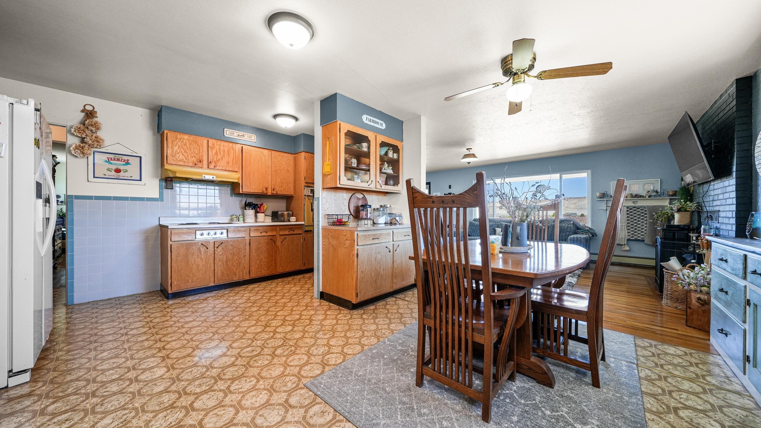 3445 C C 1/2 Road Palisade, CO 81526 - Photo 10 of 37 a kitchen with stainless steel appliances a table chairs and a refrigerator