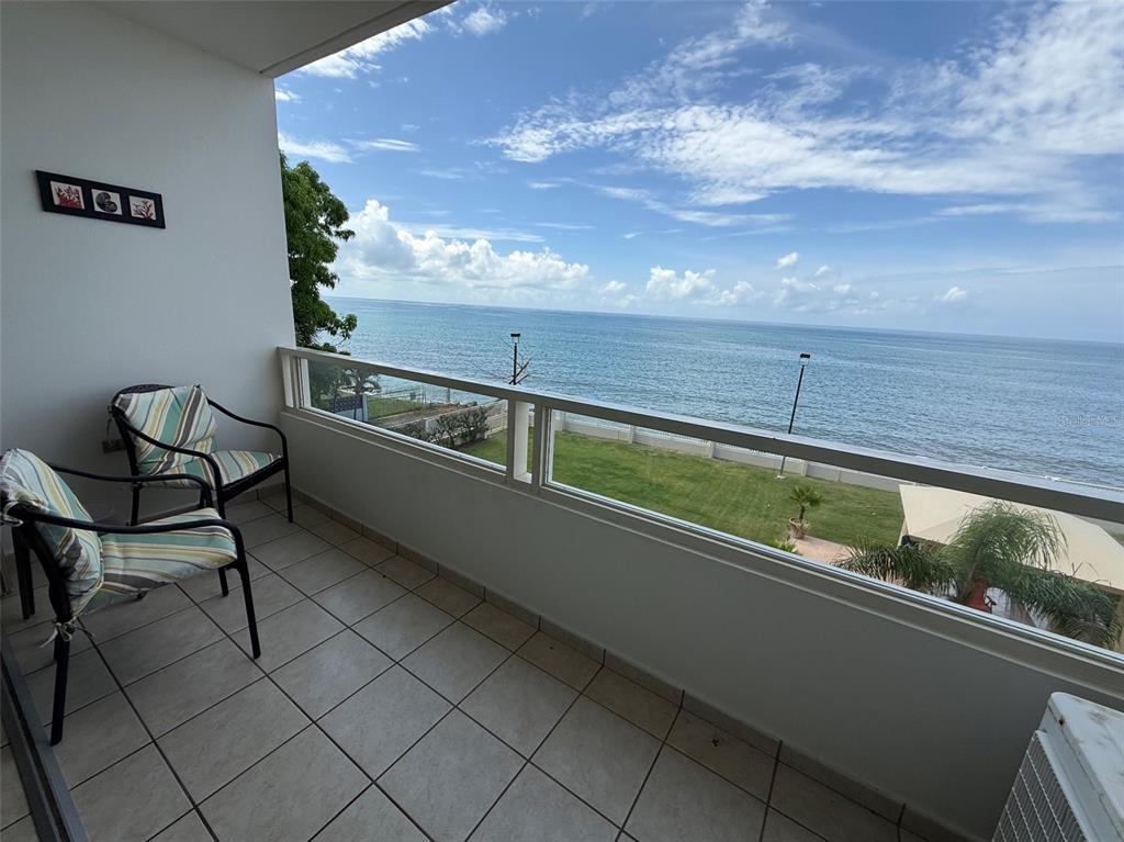 Condo Pelican Reef Condo Pelican Reef, Unit 302 Rincon, PR 00677 - Photo 1 of 16 a view of sitting area in the balcony