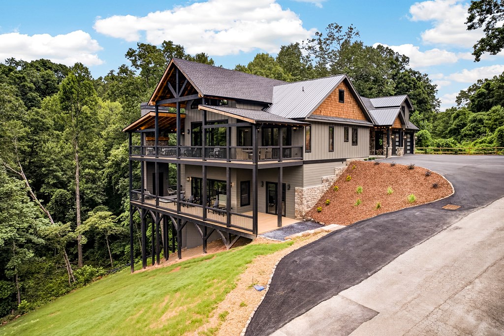 44 Staurolite Mountain Road Blue Ridge, GA 30513 - Photo 7 of 108 a front view of house with yard outdoor seating and barbeque oven