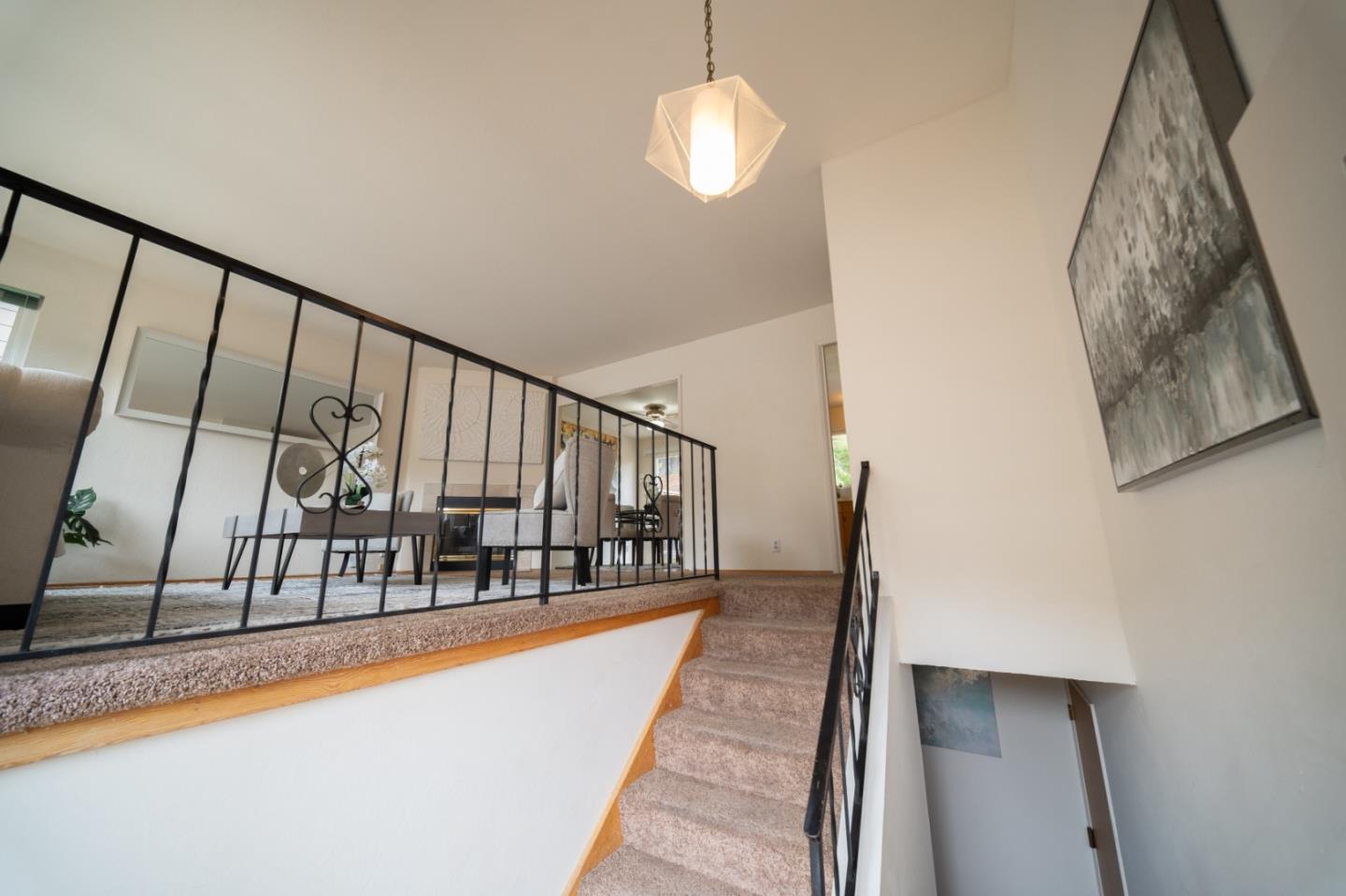 1287 Lerida Way Pacifica, CA 94044 - Photo 11 of 52 a view of staircase with white walls and railing