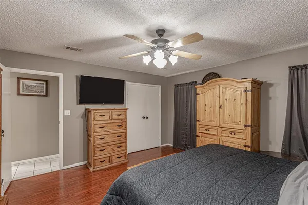 a view of a bedroom with closet and flat screen tv