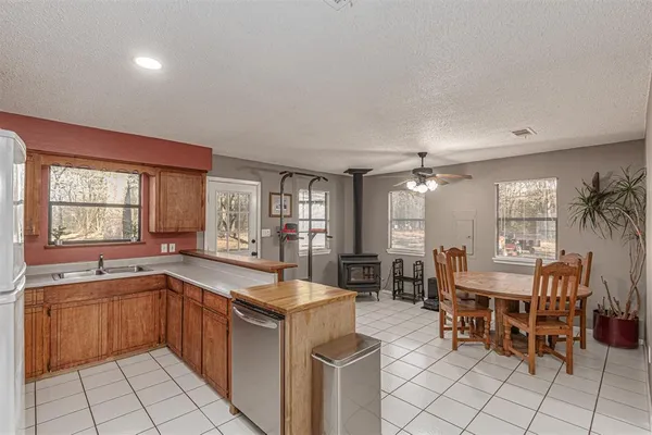 a kitchen with sink cabinets and dining table
