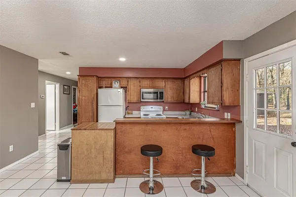 a kitchen with appliances a sink and cabinets