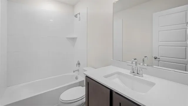 a bathroom with a sink toilet vanity and shower