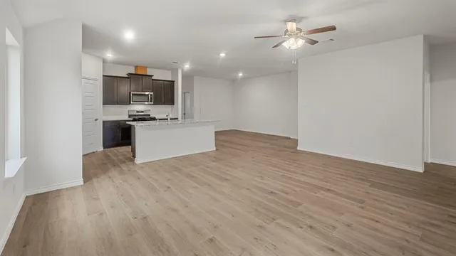 a bathroom with a granite countertop sink a mirror and bathtub