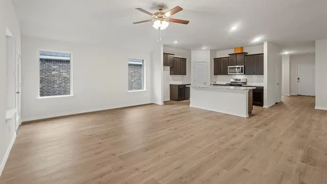 a view of kitchen with sink microwave and stove